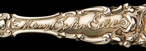 Close-up views of spoon handle with Eddy’s likeness and signature.