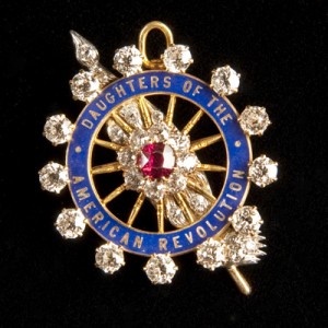 Eddy's DAR pin is set with diamonds and a ruby and has a hinged bale so that it can also be worn as a pendant. Engraved on the back is Eddy's membership number: 1423. It is marked J.E. Caldwell and Co.