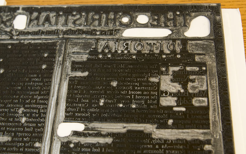 A metal plate of The Christian Science Monitor (up close)