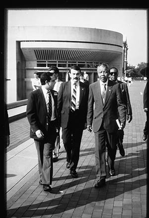 Nelson Mandela walking alongside the reflecting pool on the Christian Science Plaza