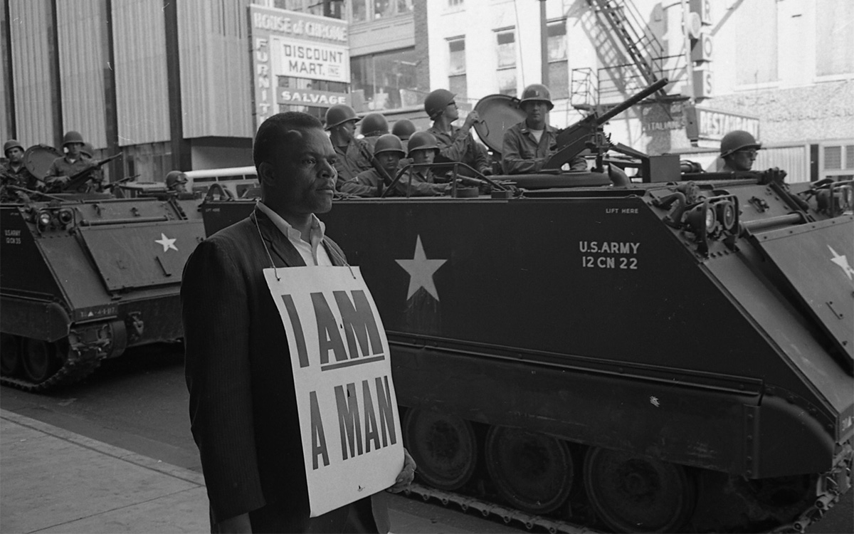 I Am A Man - Box_530211_F537784_-_Photo_1-resized Archival photo: A protestor stands in front of military tanks, with a sign around his neck that states "I am a man."