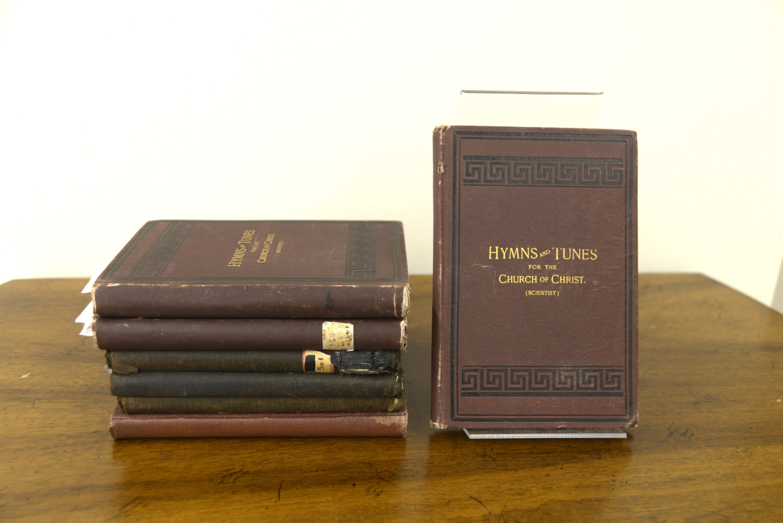 Photo of early hymnals in a stack of books